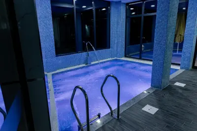 a jacuzzi tub in a building at night at SIBIYA Hotel in Ognyanovo