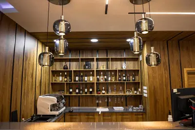 a bar with a shelf of alcohol bottles at SIBIYA Hotel in Ognyanovo