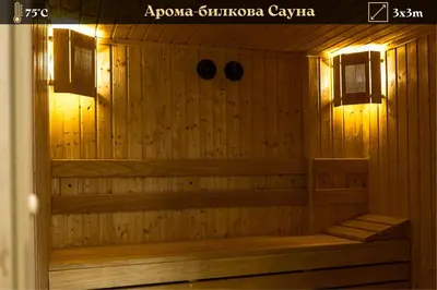 a sauna with wooden walls and lights in a room at SIBIYA Hotel in Ognyanovo