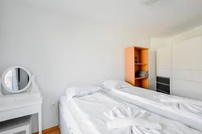 a white bedroom with a bed and a mirror at Stylish 1BD Apt in Lozenets with large balcony by Flat Manager in Sofia
