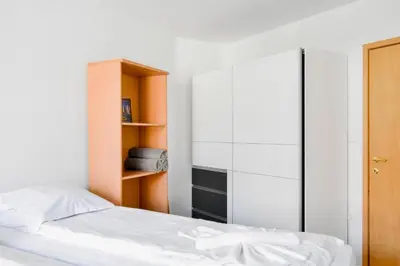 a bedroom with a bed and a book shelf at Stylish 1BD Apt in Lozenets with large balcony by Flat Manager in Sofia
