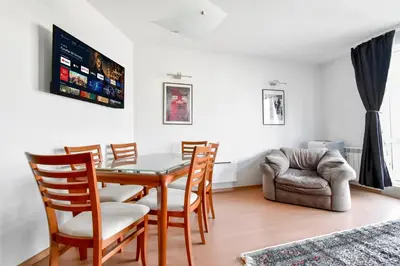 a dining room with a table and chairs and a couch at Stylish 1BD Apt in Lozenets with large balcony by Flat Manager in Sofia
