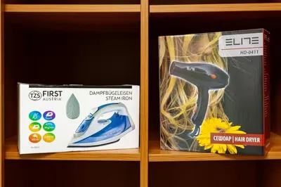 a shelf with a first intelligent vacuum cleaner and a box at Spacious 2BR Apt Kremena 10 minutes walk to Center in Plovdiv