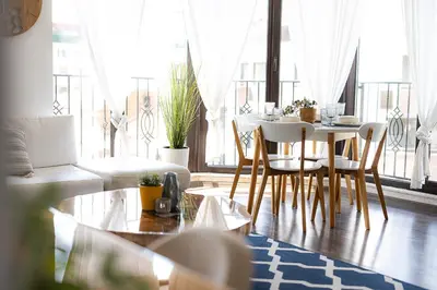 a dining room with a table and chairs in a living room at Mall of Sofia - UrbanLux Ampla 2BDR FREE Parking in Sofia