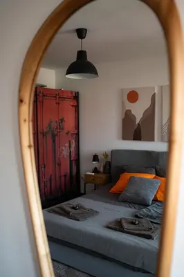 a bedroom with a bed and a red door at Mall of Sofia - UrbanLux Ampla 2BDR FREE Parking in Sofia