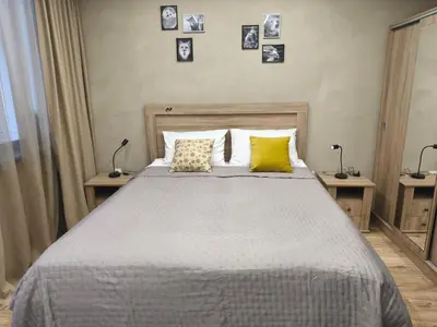 a bedroom with a bed with two lamps and pictures on the wall at Borovets Gardens Forest STUDIO A3 - FREE PARKING,Free baby cot in Borovets