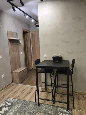 a black table and chairs in a room at Borovets Gardens Forest STUDIO A3 - FREE PARKING,Free baby cot in Borovets