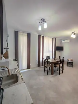 a living room with a table and some chairs at Apartment Active Sport in Pazardzhik