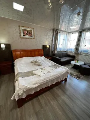 a bedroom with a bed and a living room at Complex Koko Hills in Sapareva Banya