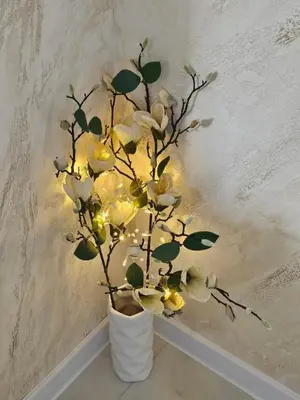 a flower arrangement in a vase with lights at Apartment Home in Troyan