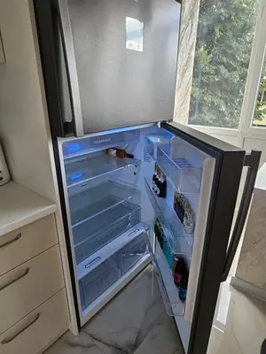an empty refrigerator with its door open in a kitchen at Apartment Home in Troyan