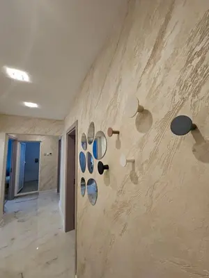 a room with a wall with mirrors on the wall at Apartment Home in Troyan