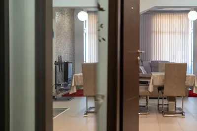 a view of a dining room with a table and chairs at Sofia Downtown Apartment in Sofia