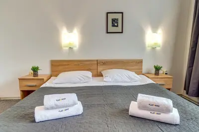 a bedroom with a bed with two towels on it at Villa Kometa - 1BD Apt with Balcony & Forest View by Flat Manager in Pamporovo