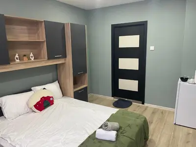 a bedroom with a bed with a red backpack on it at GuestHouse Karma369 in Plovdiv
