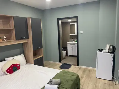 a small bedroom with a bed and a bathroom at GuestHouse Karma369 in Plovdiv