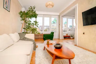 a living room with a white couch and a table at TERRA Design - Award-Winning Apartment - by Flat Manager in Sofia
