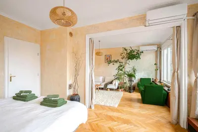 a bedroom with a bed and a living room at TERRA Design - Award-Winning Apartment - by Flat Manager in Sofia
