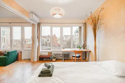a bedroom with a large white bed and windows at TERRA Design - Award-Winning Apartment - by Flat Manager in Sofia