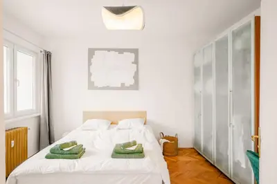 a bedroom with a white bed with green towels on it at TERRA Design - Award-Winning Apartment - by Flat Manager in Sofia