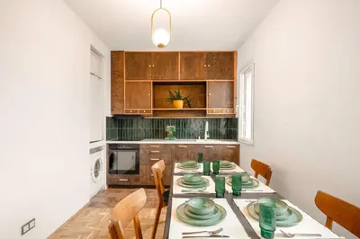 a kitchen with a table with green dishes on it at TERRA Design - Award-Winning Apartment - by Flat Manager in Sofia