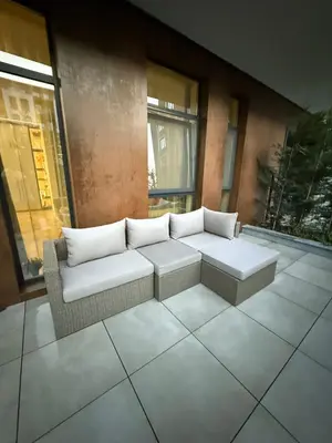 a white couch sitting in a room with windows at The Giraffe's apartment in Sofia