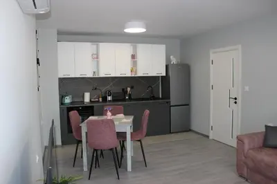 a kitchen and dining room with a table and chairs at Candy 26 Apartment in Velingrad