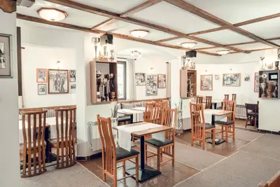 a dining room with wooden tables and chairs at Complex Popangelov in Borovets