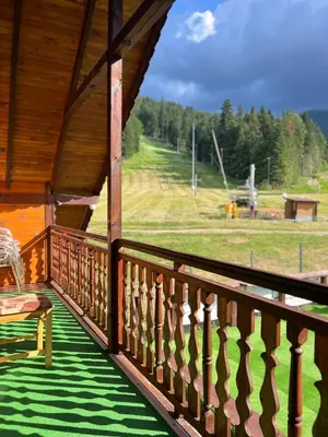 a porch with a chair and a view of a field at Complex Popangelov in Borovets