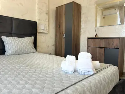 a bedroom with a bed with towels on it at Платинум 8 in Plovdiv