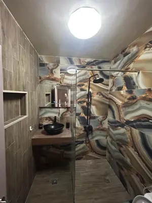 a bathroom with a sink and a glass shower stall at Платинум 8 in Plovdiv
