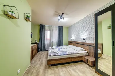 a bedroom with a bed and a mirror at Two Cozy Mint Studios in Grand Resort Pamporovo by Flat Manager in Pamporovo