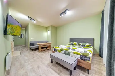 a bedroom with a bed and a flat screen tv at Two Cozy Mint Studios in Grand Resort Pamporovo by Flat Manager in Pamporovo