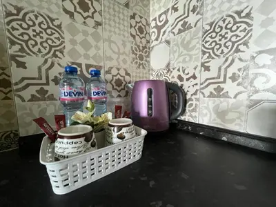 a counter with two bottles of water and mugs at Einstein apartment in Sofia