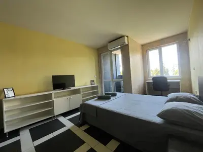 a bedroom with a bed and a flat screen tv at Einstein apartment in Sofia