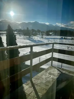 a view from a balcony with a fence and snow at Chalet Hamars - Highland Haven in Razlog