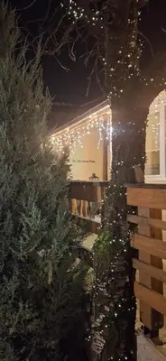 a christmas tree with christmas lights on a building at The Old Cherry House in Razlog