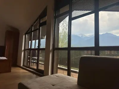 a room with large windows with a view of mountains at Top floor and mountain views in Razlog