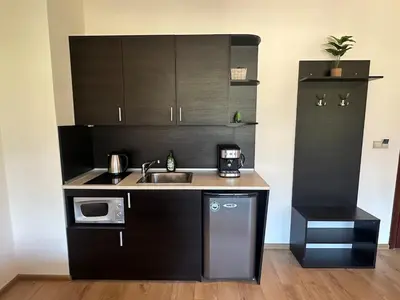 a small kitchen with a sink and a microwave at Top floor and mountain views in Razlog