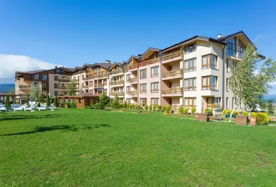 a large apartment building with a large green yard at Top floor and mountain views in Razlog