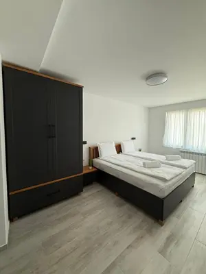 a bedroom with a large bed and a large cabinet at Gorna Banya luxury apartments in Sofia