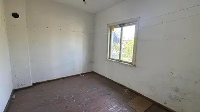 an empty room with a window and a wooden floor at Pazardzhik Shelter House 3 Empty Rooms, No Electric, No Water, No WC, Free Car Parking, Glavinitsa Self Check-in
