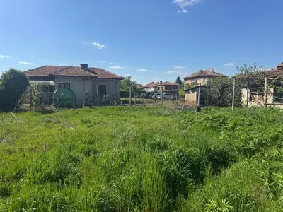 a field of grass with a house in the background at Pazardzhik Shelter House 3 Empty Rooms, No Electric, No Water, No WC, Free Car Parking, Glavinitsa Self Check-in