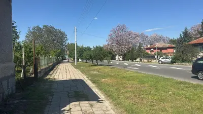 a brick sidewalk next to a road with a fence at Pazardzhik Shelter House 3 Empty Rooms, No Electric, No Water, No WC, Free Car Parking, Glavinitsa Self Check-in