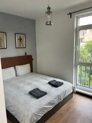 a bedroom with a bed with two towels on it at Cozy apartment, by Paradise Mall in Sofia