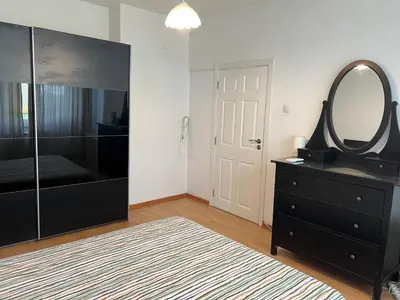 a bedroom with a mirror and a dresser with a dresser at South Park in Sofia