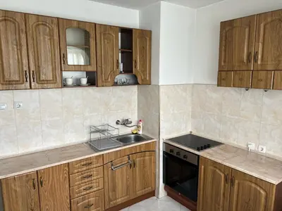 a kitchen with wooden cabinets and a sink at South Park in Sofia