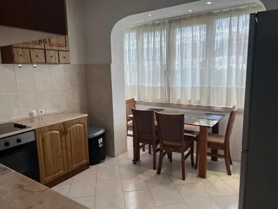 a kitchen with a table and chairs and a window at South Park in Sofia
