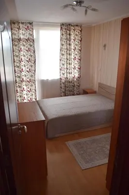 a small bedroom with a bed and a window at Pirin 7 in Pazardzhik