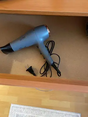 a blue blow dryer in a wooden drawer at Pirin 7 in Pazardzhik